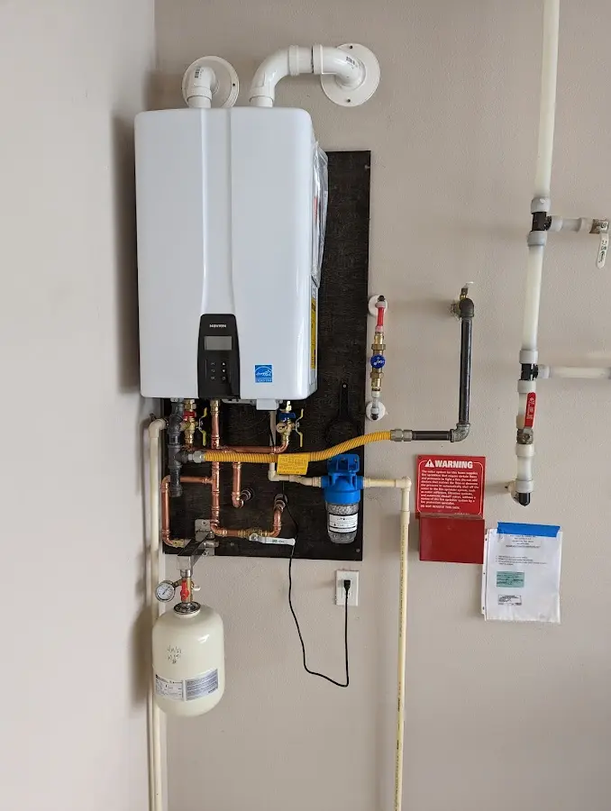 Professional plumber installing copper piping in a Middleville home